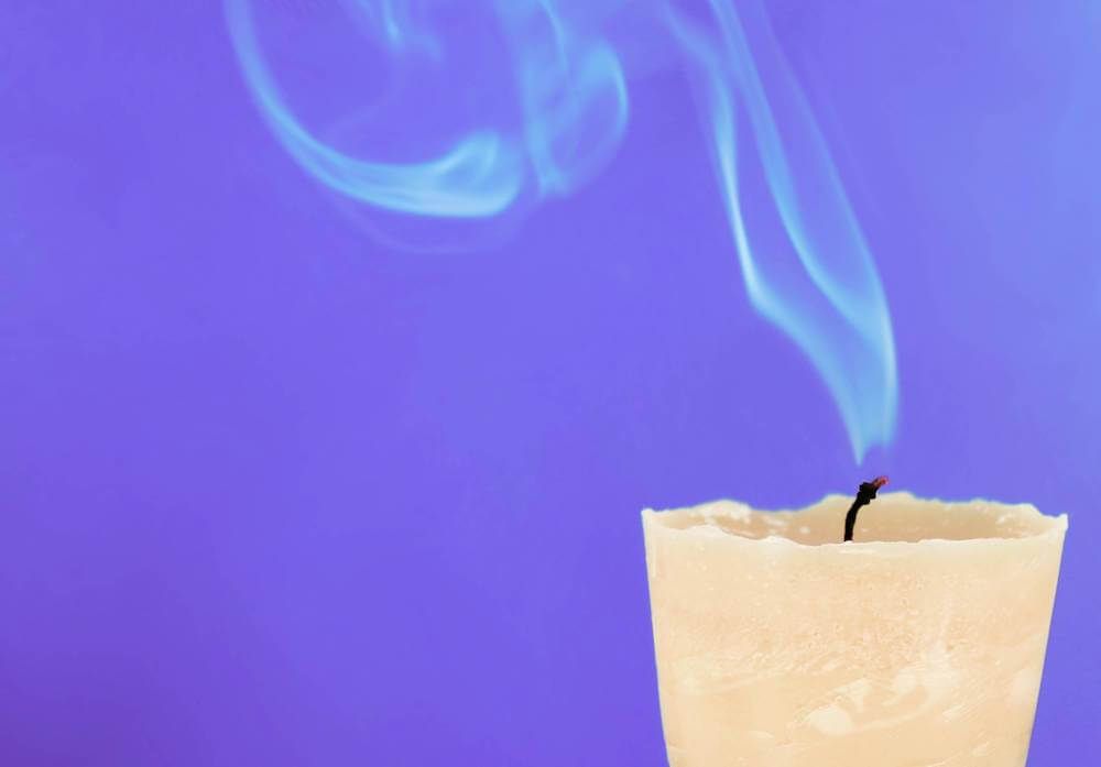 trimming the wick regularly can help eliminate excess soot that contributes to bad smells from candles.