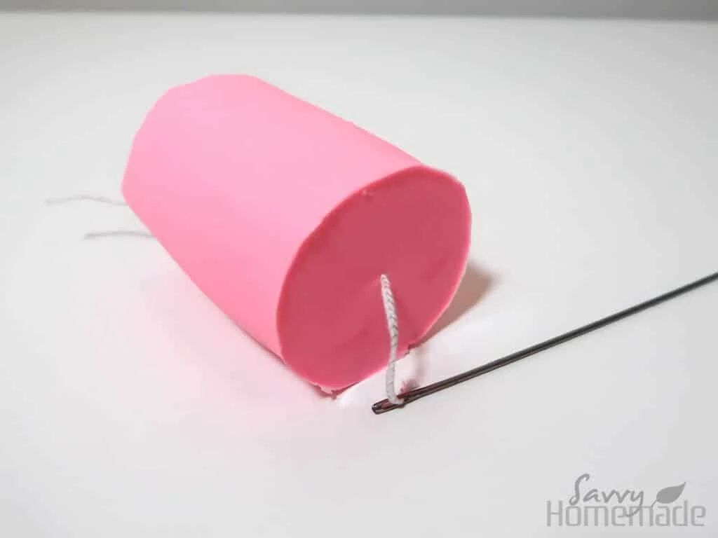 use high temp silicone or craft glue to reattach a detached candle wick.