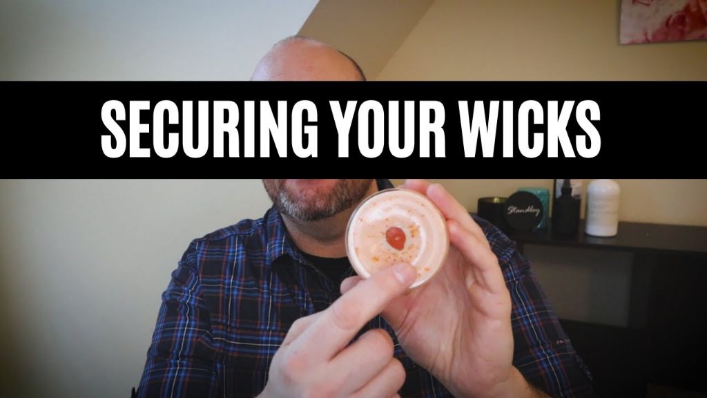 using glue dots or wick stickers helps secure the wick in place when pouring wax.