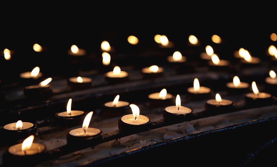 votive candles burning in a church