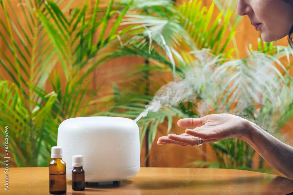 woman enjoying essential oils diffuser