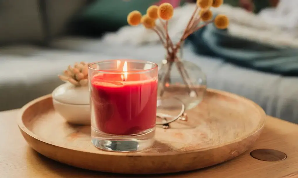 a car scent candle burning safely in a cup holder