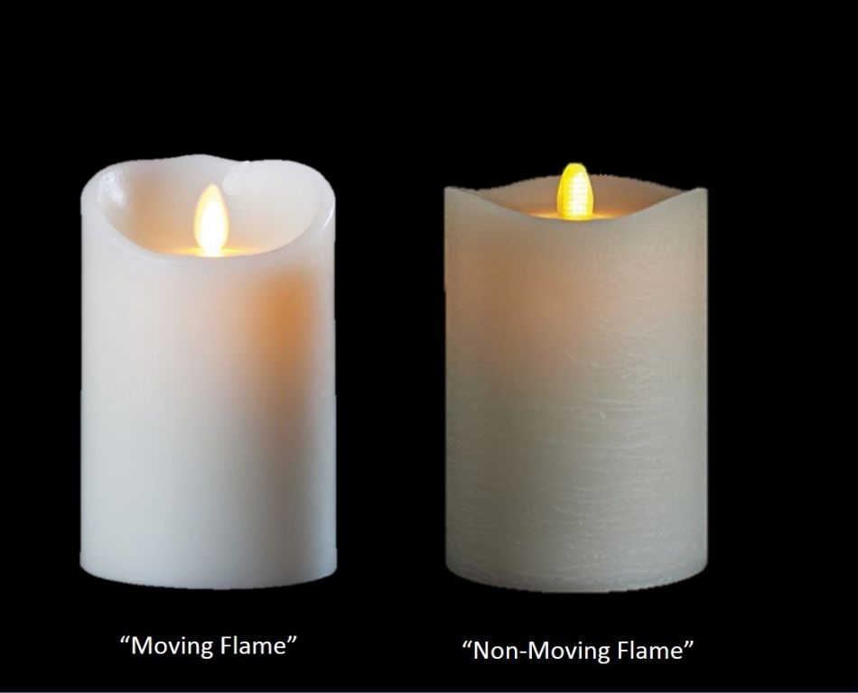 a flameless candle with a realistic wax exterior sits on a table next to a burning wax candle.