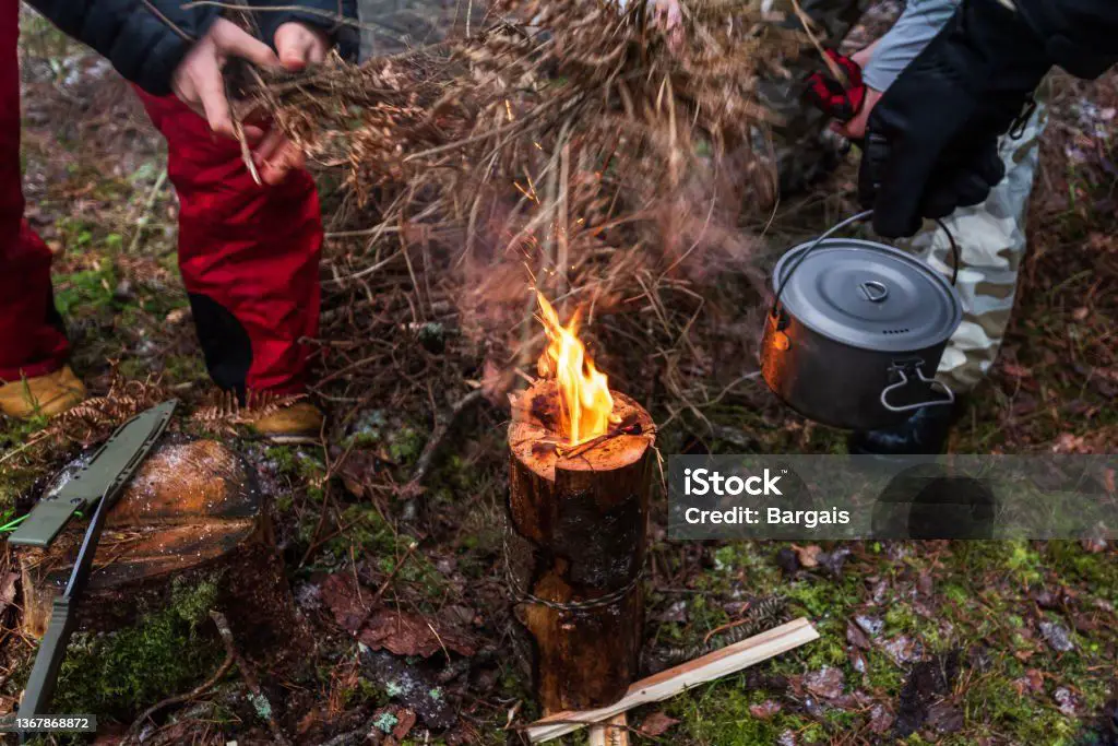 person cooking over a candle flame