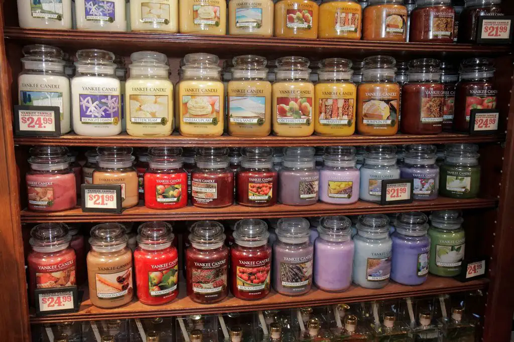 reused jars displayed on shelves in yankee candle store