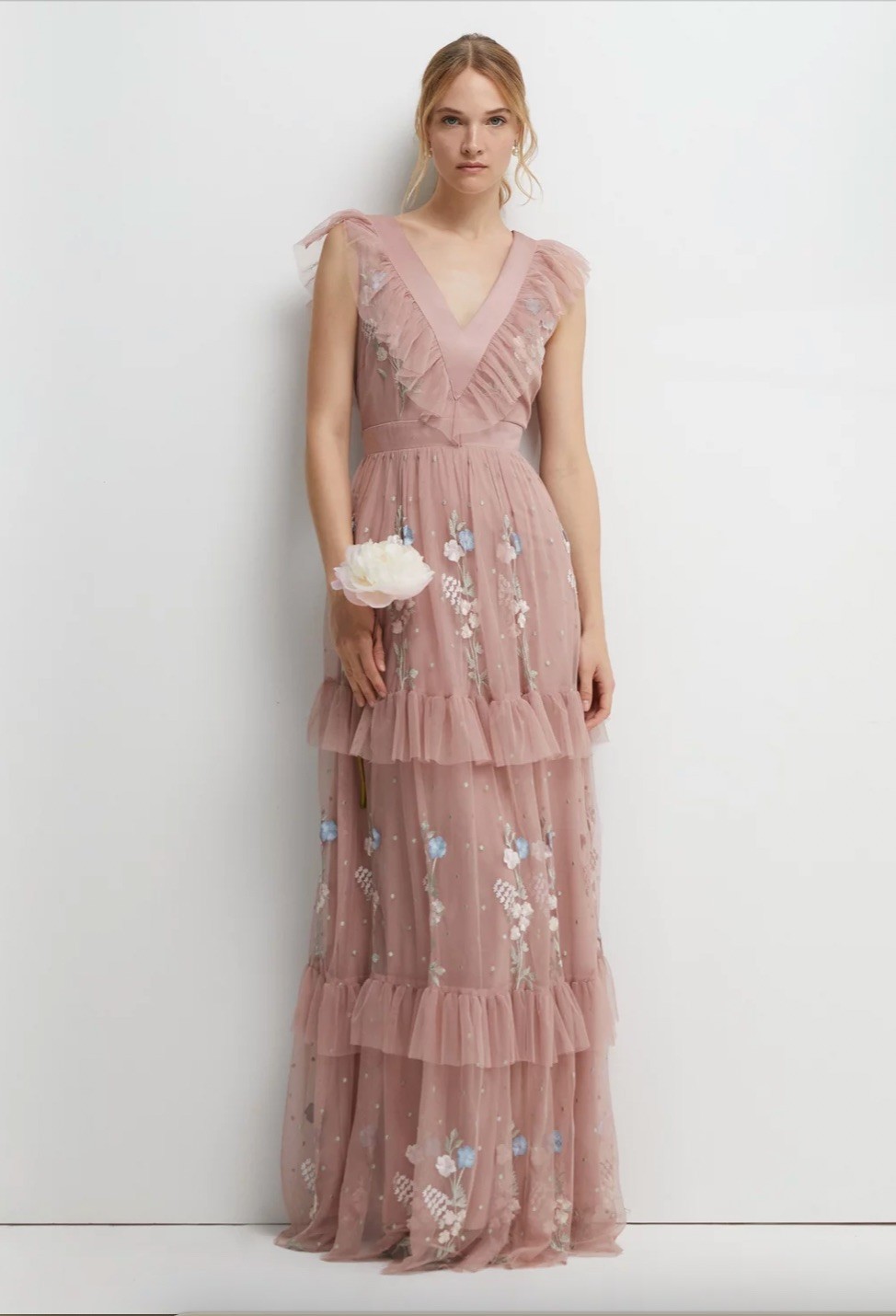 Shower a tulle gown with whimsical elements like sequins, pearls, and colorful floral embroidery. This fairy-like ensemble will be perfect for a garden wedding, or a blush theme.