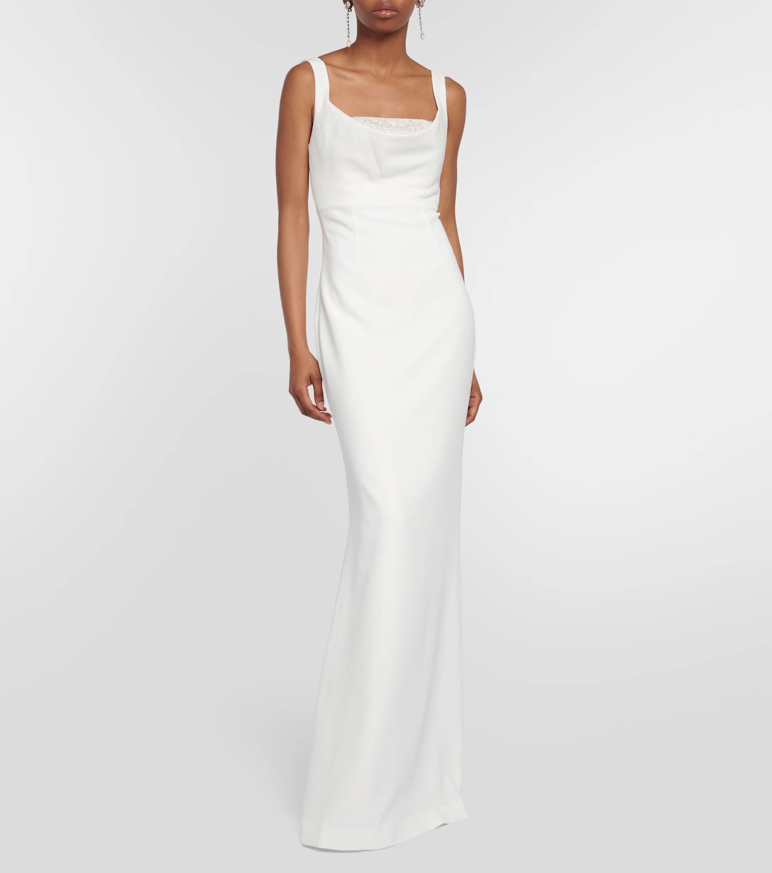 For an artsy wedding in a minimalist venue, wear a spiced-up column gown with a peekaboo crystal corset bodice.