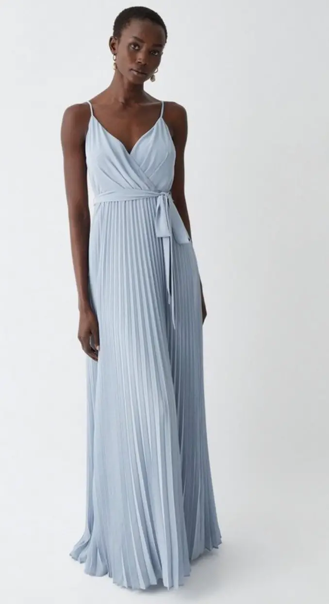 Another simply classy dress style for bridesmaids is the wrap or surplice neckline, in which one panel of fabric crosses over the other, leaving a relaxed v-shape. Slip into this straightforward dress with a pleated skirt and bow detail to exude subtle elegance.