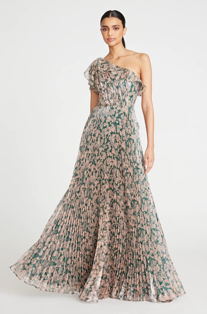 Team pleats and impressionistic florals in a breeze-ready off-shoulder dress. Light and airy, this flouncy style is apt for both garden and beach weddings.