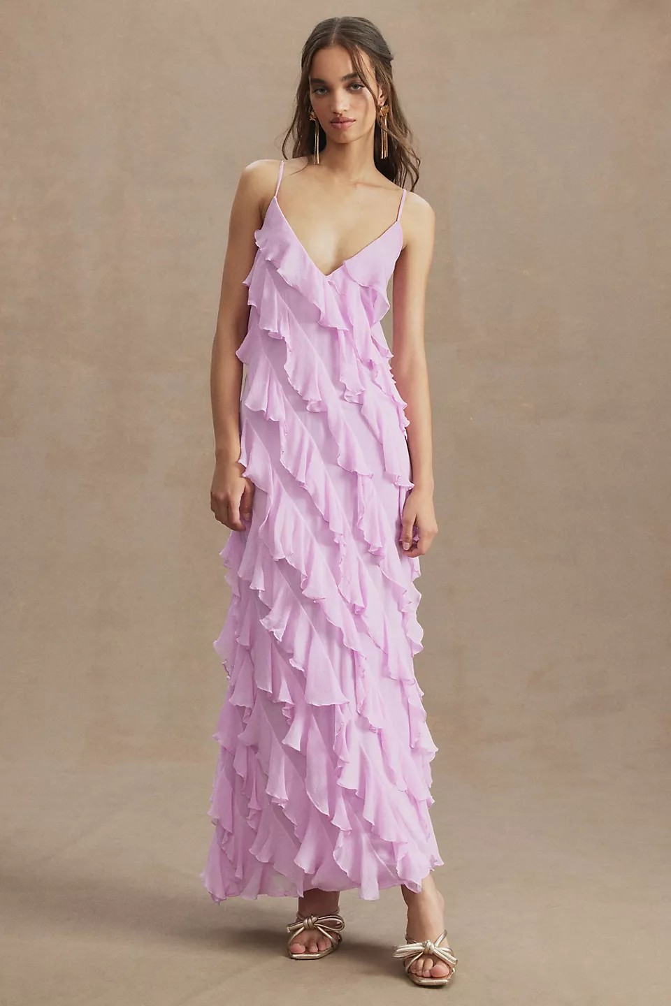 Modern and exuberant, this dynamic gown features diagonal cascading ruffles, which completely elevate the simple slip silhouette.