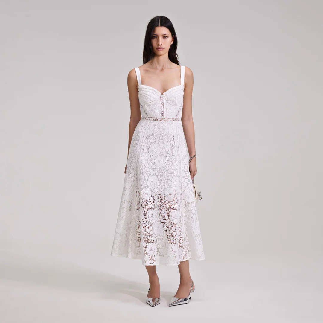 For a countryside or ranch wedding, don a lacy a-line midi dress with a sheer skirt, bustier-style bodice, and beautiful panels.